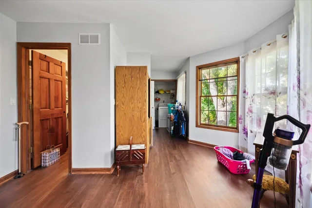 a view of a room with furniture and wooden floor