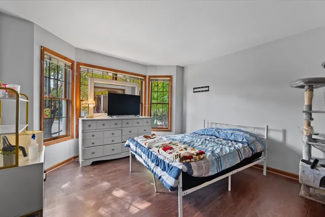 a bed room with a bed and a flat tv screen