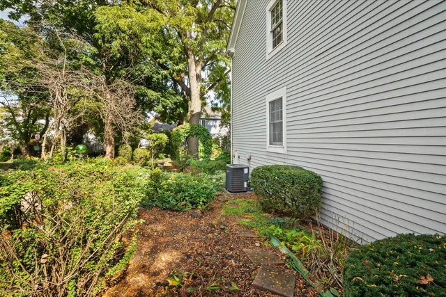 a yellow house with lots of green space
