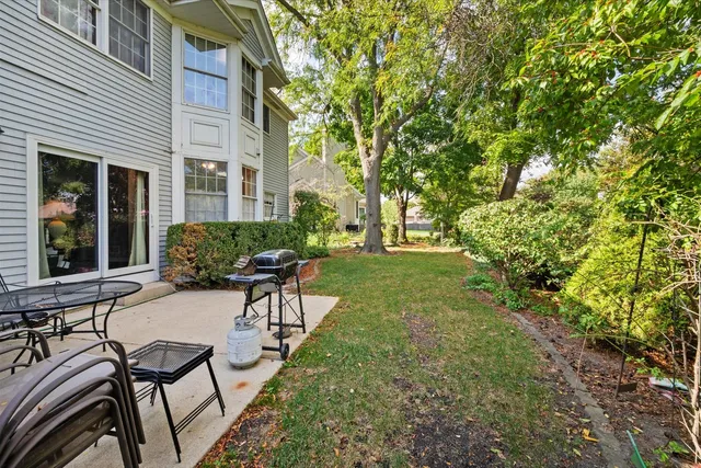 a view of a house with backyard and sitting area
