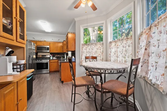 a dining room with furniture and wooden floor