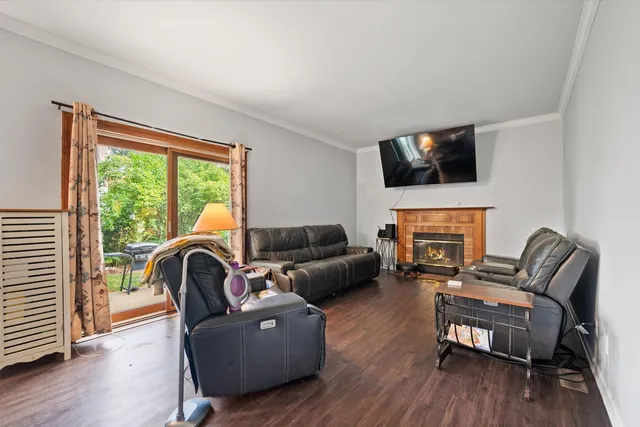 a living room with furniture a fireplace and a flat screen tv