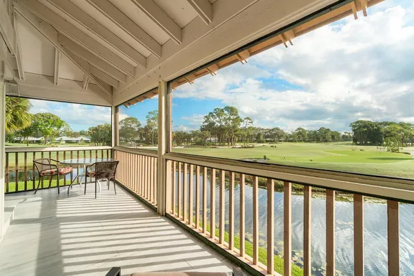 a view of balcony with mountain view and wooden floor