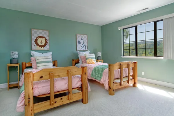 a spacious bedroom with a bed and a couch