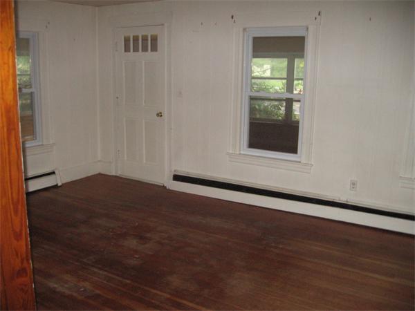 68 Fitchburg Road Townsend, MA 01469 - Photo 7 of 17 an empty room with wooden floor and windows
