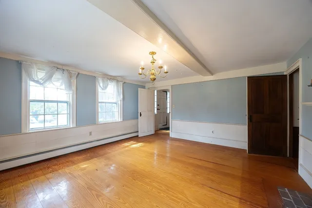 wooden floor in an empty room with a window