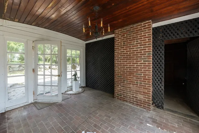a view of an empty room with a fireplace and a window