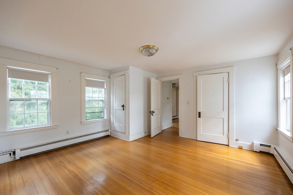 9 Abigail Drive Hudson, MA 01749 - Photo 23 of 36 an empty room with wooden floor and windows