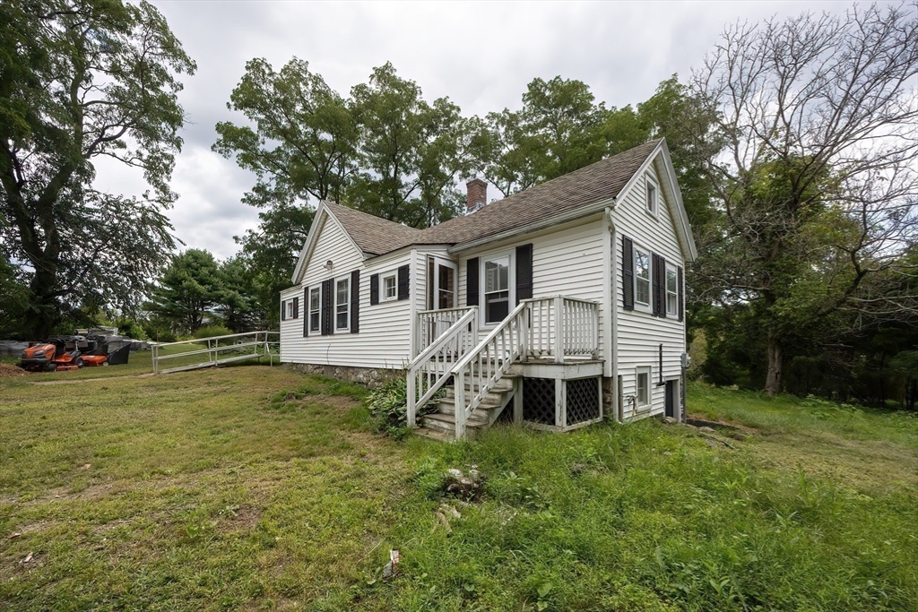 9 Abigail Drive Hudson, MA 01749 - Photo 33 of 36 a front view of a house with a garden and trees