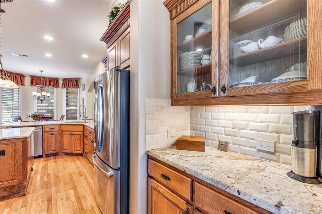 1109 Canton Court Allen, TX 75013 - Photo 12 of 40 a kitchen with granite countertop stainless steel appliances a sink and counter space