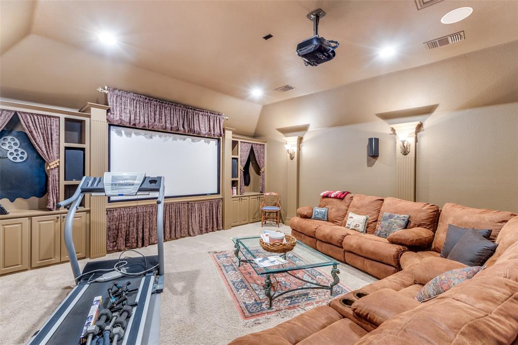 1109 Canton Court Allen, TX 75013 - Photo 15 of 40 a living room with furniture a flat screen tv and a table