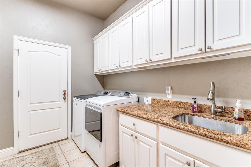 1109 Canton Court Allen, TX 75013 - Photo 19 of 40 a kitchen with granite countertop white cabinets and a sink