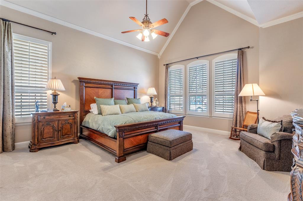 1109 Canton Court Allen, TX 75013 - Photo 21 of 40 a bedroom with a bed and a chandelier