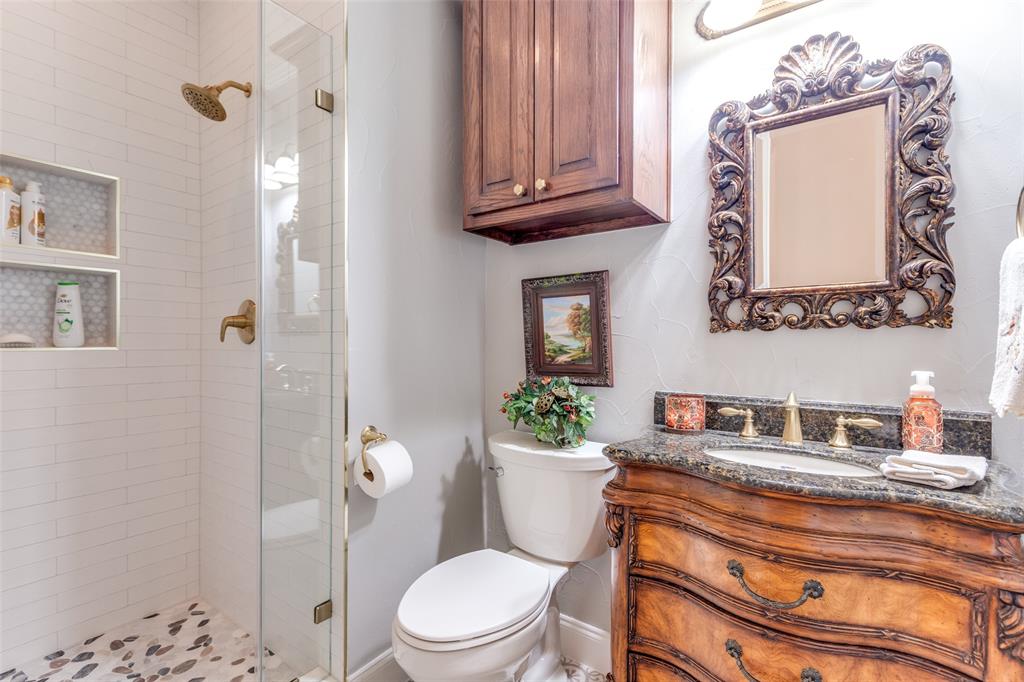 1109 Canton Court Allen, TX 75013 - Photo 26 of 40 a bathroom with a toilet a sink and shower curtain