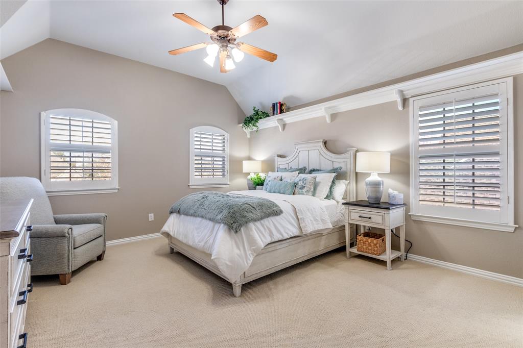 1109 Canton Court Allen, TX 75013 - Photo 29 of 40 a bedroom with a bed a chandelier and a couch