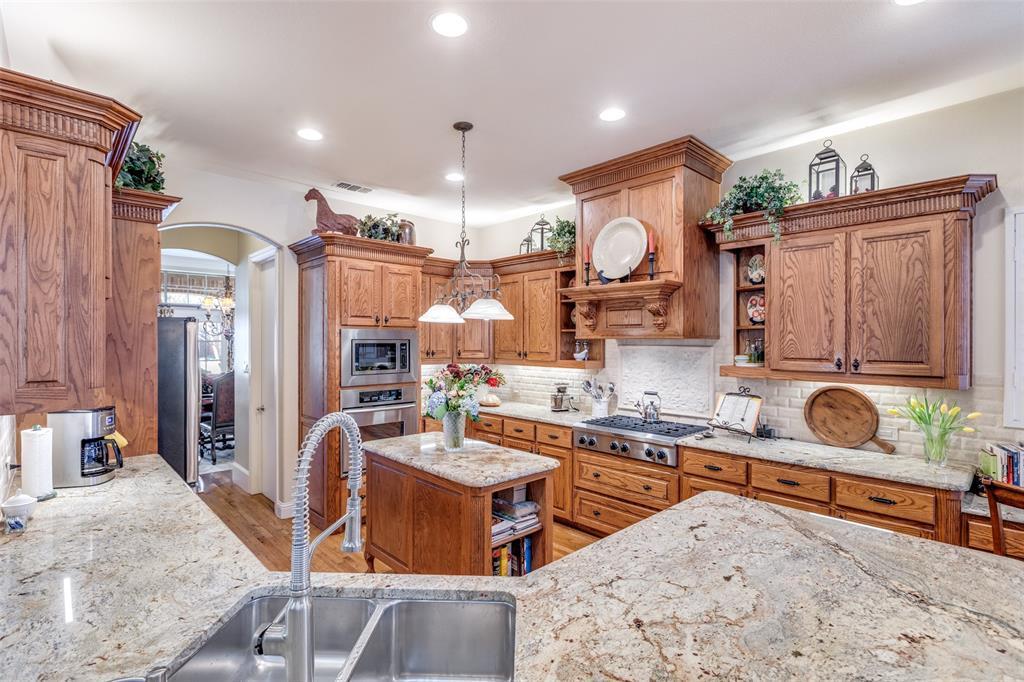 1109 Canton Court Allen, TX 75013 - Photo 8 of 40 a kitchen with a sink stove and cabinets