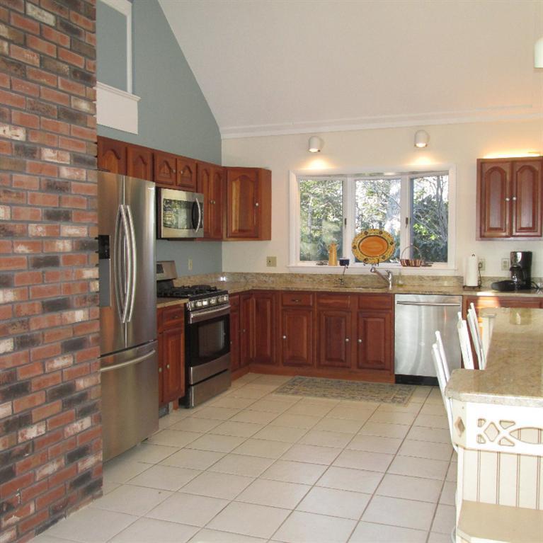 3 Plow Penny Road Bourne, MA 02532 - Photo 18 of 35 a kitchen with stainless steel appliances granite countertop a stove a sink and a refrigerator