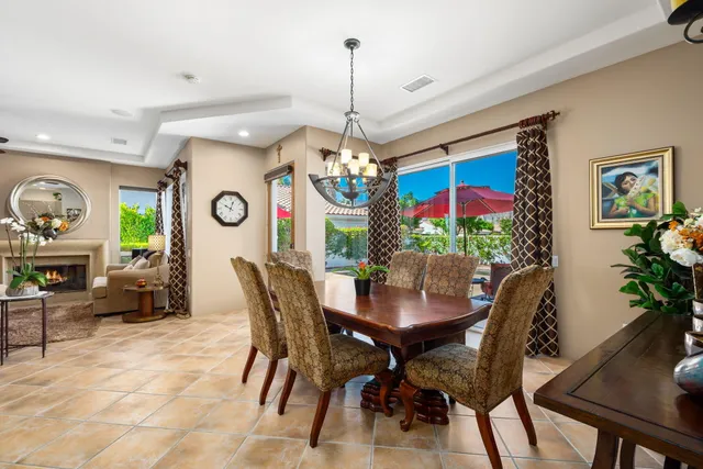 a view of a dining room with furniture and a chandelier