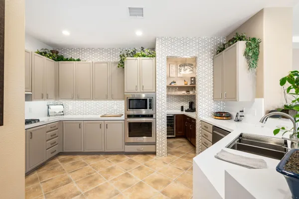 a kitchen with a stove sink and cabinets