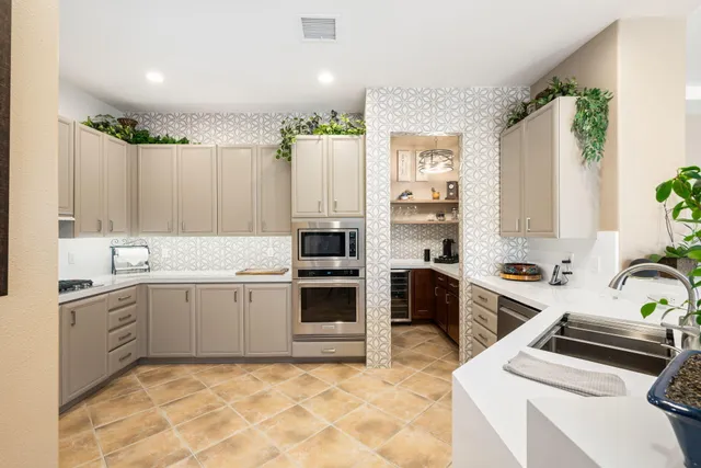 a kitchen with a stove sink and cabinets