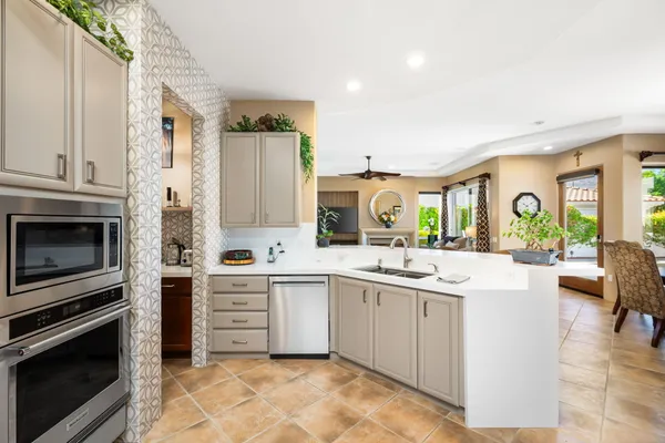 a kitchen with a sink stove and cabinets