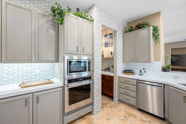 a kitchen with a sink stove and microwave