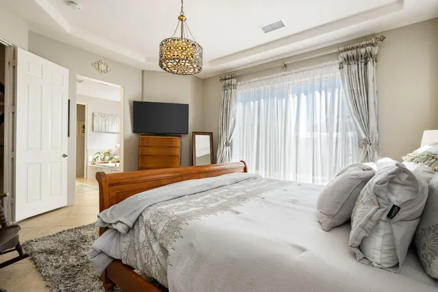 a bedroom with a bed and a chandelier