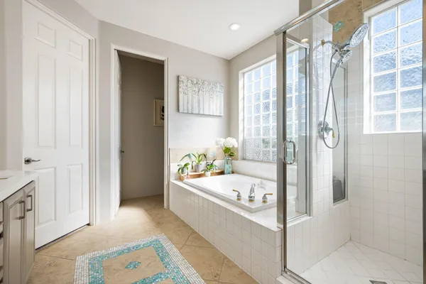 a bathroom with a bathtub and a shower