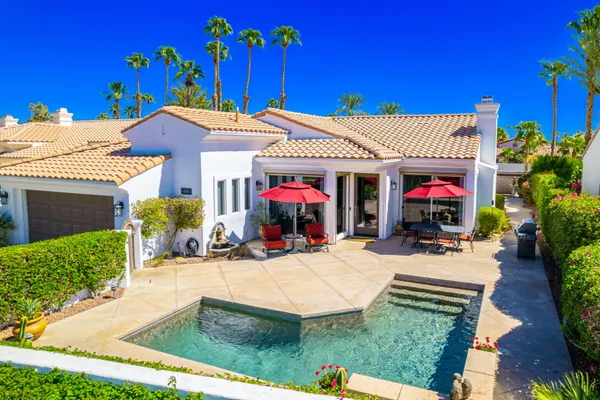 a view of a house with potted plants