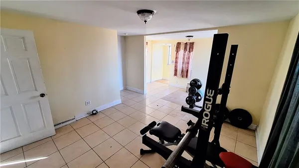 a view of a hallway to a livingroom with furniture and windows