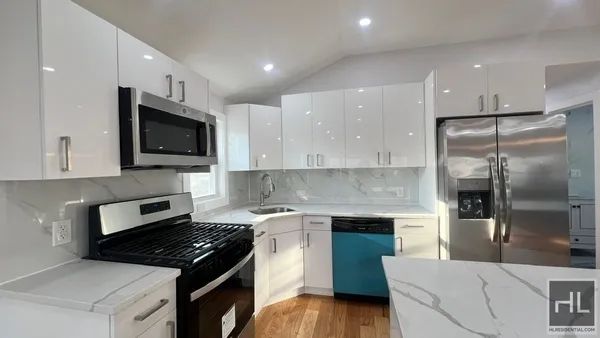 a kitchen with a sink stove and microwave