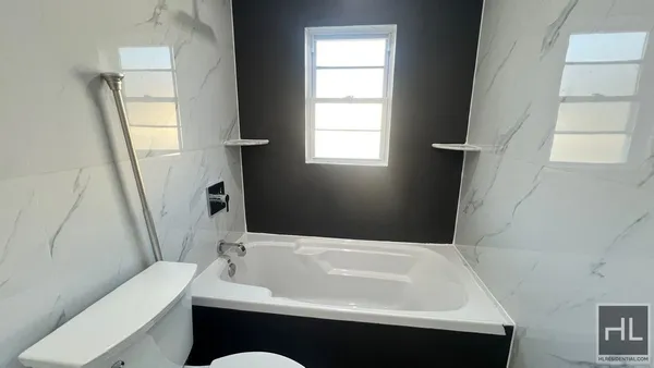a bathroom with a bathtub sink and toilet
