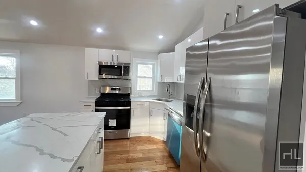 a kitchen with a refrigerator and a stove top oven