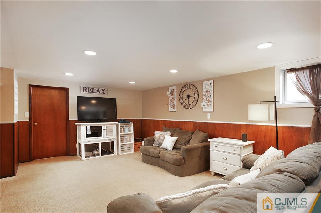 15 Ferris Road Edison, NJ 08817 - Photo 17 of 24 a living room with furniture and a flat screen tv