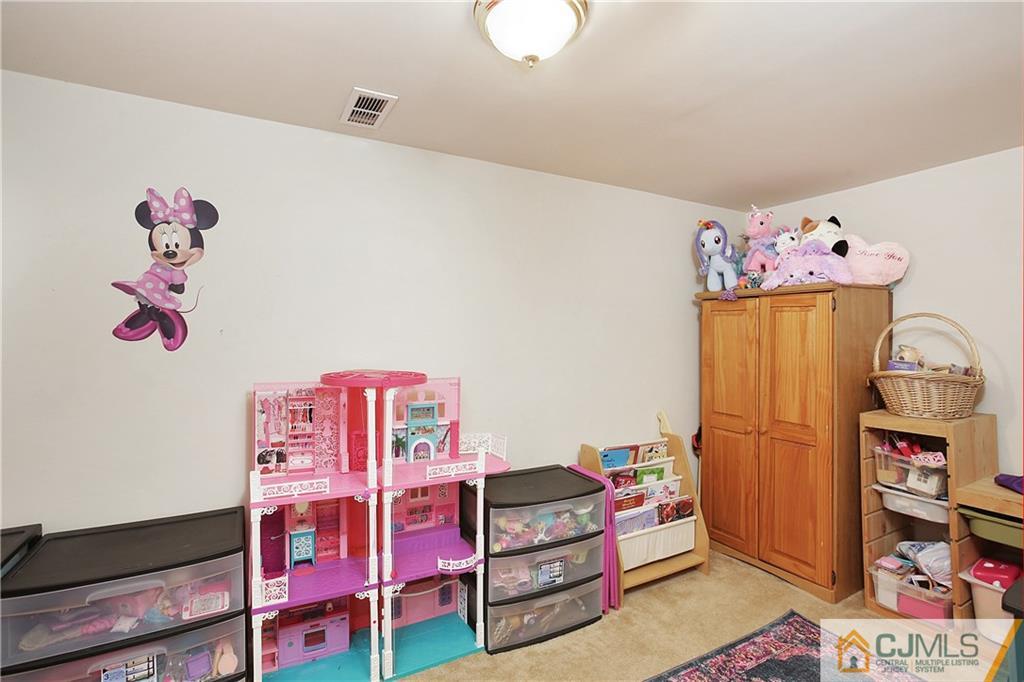 15 Ferris Road Edison, NJ 08817 - Photo 21 of 24 a bedroom with a bed and wooden floor