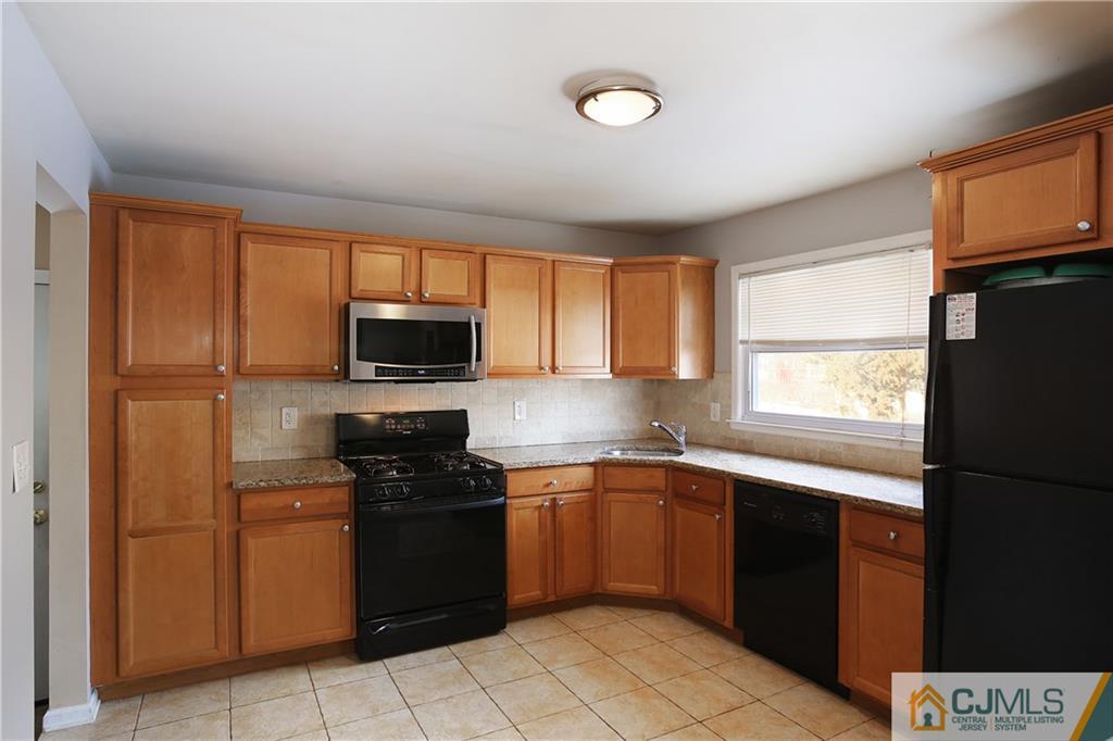 15 Ferris Road Edison, NJ 08817 - Photo 8 of 24 a kitchen with a sink stove and refrigerator