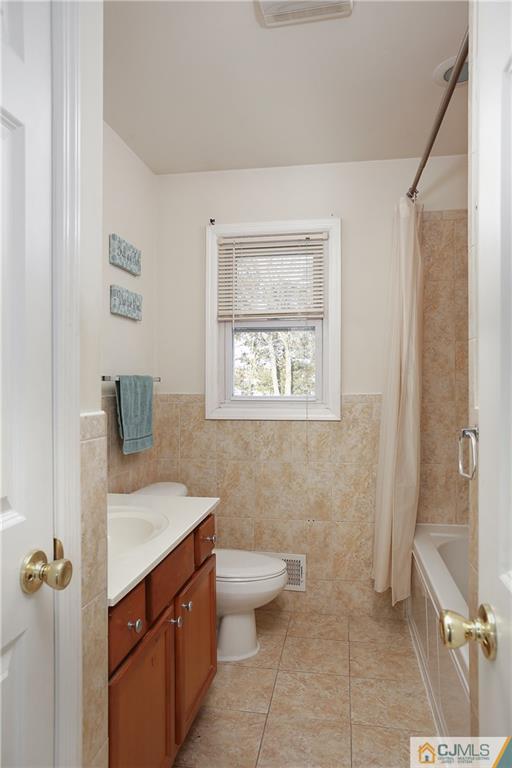 15 Ferris Road Edison, NJ 08817 - Photo 9 of 24 a bathroom with a granite countertop sink a toilet and a mirror
