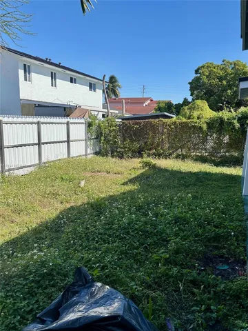 a view of a patio with dining table and chairs