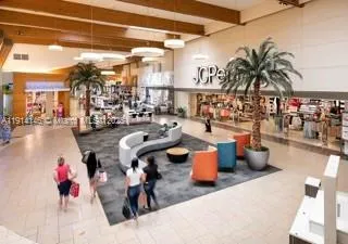 a view of a building with a large window and a palm tree