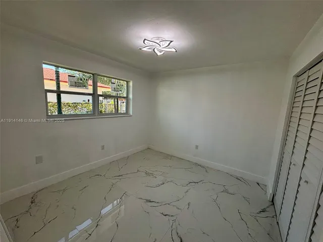 an empty room with a empty space and windows