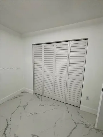 an empty room with a white door