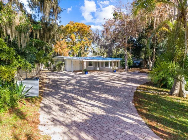 a view of a house with backyard and sitting area