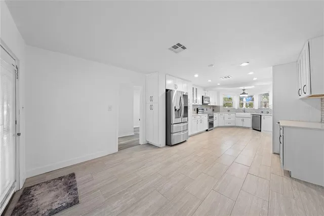an empty room with wooden floor and a window