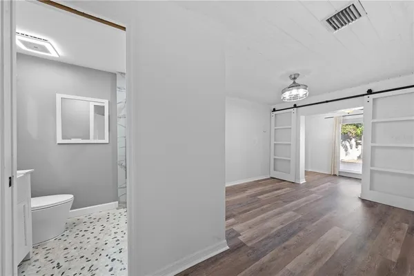 a kitchen with stainless steel appliances granite countertop a stove top oven a sink and white cabinets