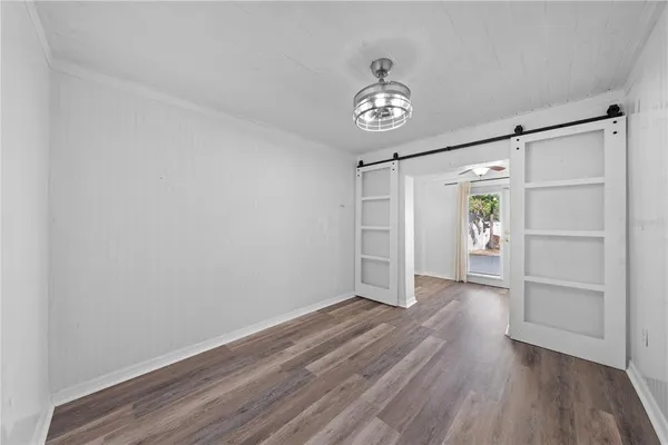 a view of hallway with stairs and wooden floor