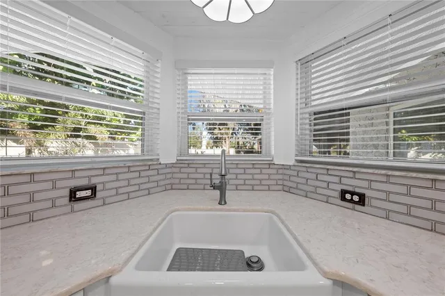 a spacious bathroom with stainless steel appliances granite countertop a sink and dishwasher with white cabinets