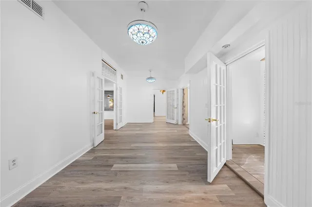 a view of an entryway with wooden floor