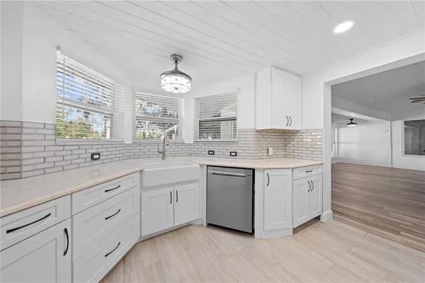 an empty room with furniture and a large window