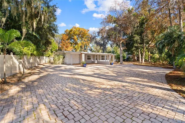 a view of a house with backyard and sitting area