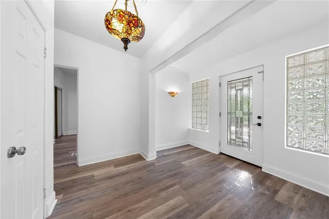 a kitchen with granite countertop white cabinets stainless steel appliances a sink and a window